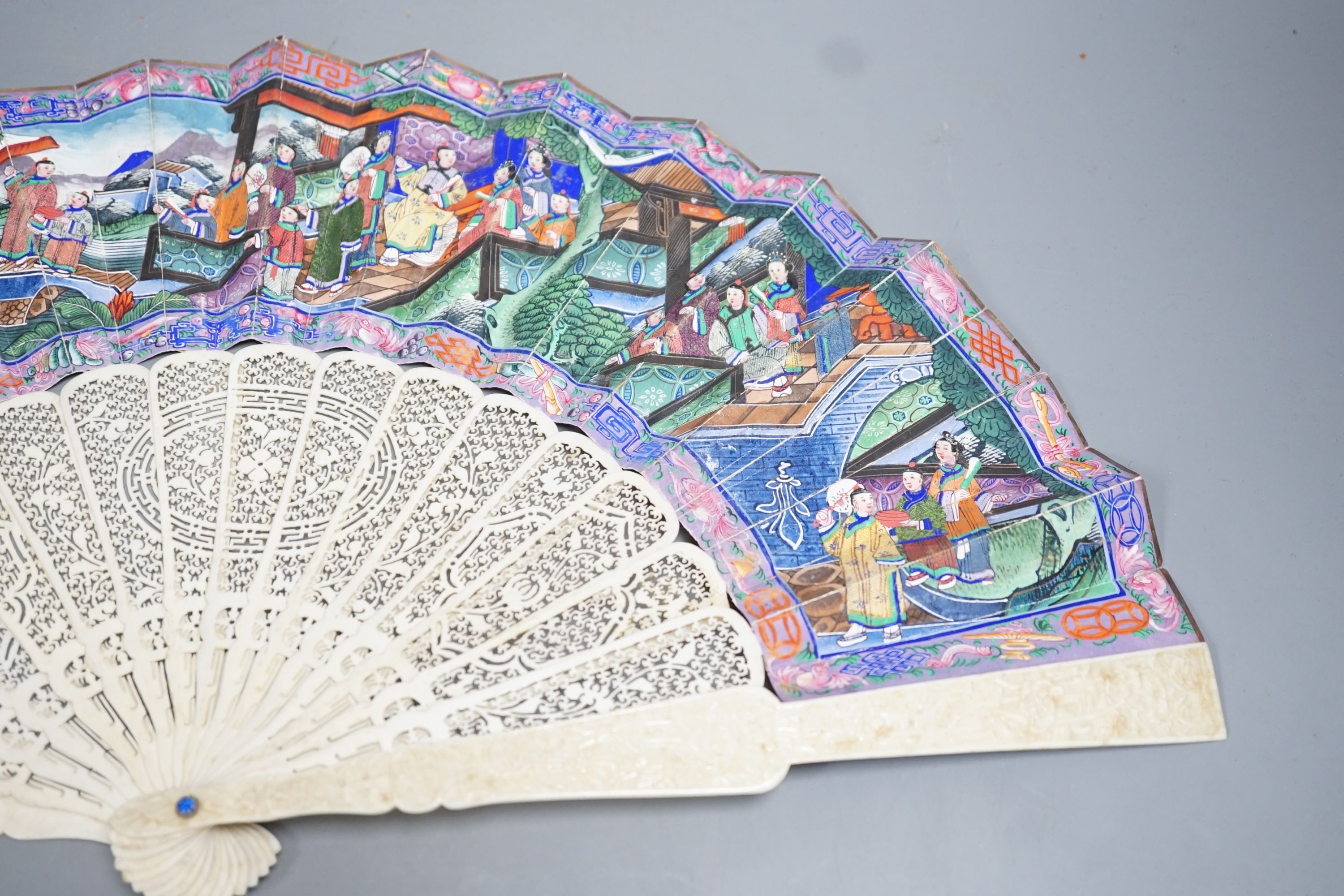 A 19th century Chinese export pierced ivory and painted paper leaf fan. 28cm long